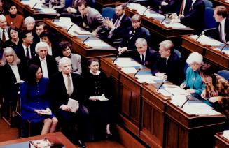 Knowing look: Premier Bob Rae exchanges an understanding glance with his wife, Arlene Perly Rae, front row left, yesterday in the Legislature