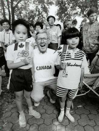 Canada boosters: Ling Hong, 7, left, and Liu Xian, 6, manage to flag down Premier Bob Rae for a picture at Queen's Park Canada Day celebrations yesterday