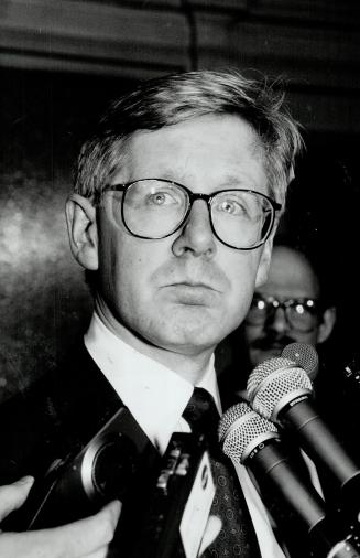 Unhappy premier: Bob Rae faces reporters after accepting his health minister's resignation and ordering a probe into his social services minister's dealings