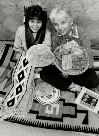 Native fare: Tecumseh Pavilion princess Nahanni Bell and Duke Redbird show off some of the bannock breads that will be served at Caravan '87