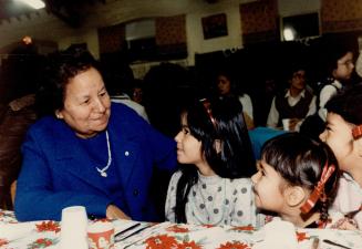 Grandma': Millie Redmond (top left), who founded a downtown centre for poor natives, talks with children who call her grandmother