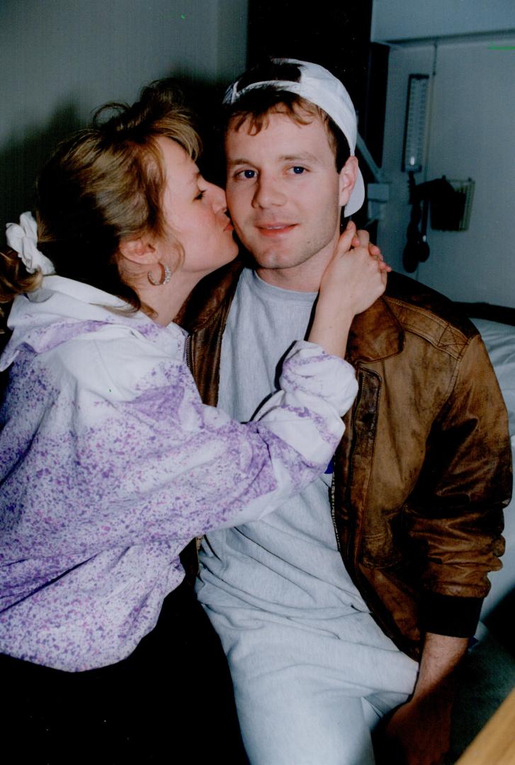 Birthday boy: Leaf goaltender Jeff Reese gets a kiss from his wife Elaine, just prior to being released from hospital yesterday, his 25th birthday