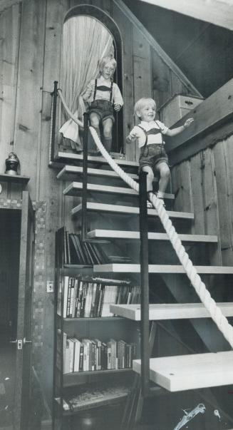 Thomas Reprich, 7, left and his brother Oliver, 5, romp down the stairs from their bedroom in the eaves of their family's renovated cottage home near (...)
