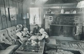 Tradition is honored. Above: Reprich family from left, Clara Reprich, Oliver, Otto Reprich and Thomas enjoy a quiet game of Monopoly. Furnishings in t(...)