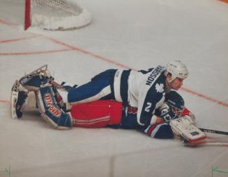 Paying the price: Rangers goaltender Bob Froese pays the price for leaving the safety of his crease and is run over by the Leaf's Luke Richardson