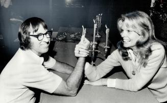 Wonder woman in a new television series, Cathy Lee Crosby arm-wrestles with Bobby Riggs, who calls himself the No
