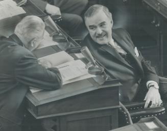 Stanley Randall, minister of economics and development, shares a light moment during yesterday's opening of the legislature with Premier Robarts. Mr. (...)