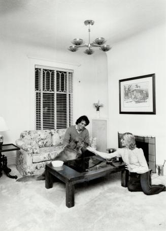 Relaxing: J.D. and Michele Roberts and golden retriever Brandon relax beside coffee table that has a backgammon board under its top. Right, pine furni(...)