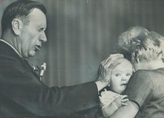 Evangelist Oral Roberts, seen praying for the healing of a baby during his Toronto crusade in 1964, is one of the faith-healers condemned in an offici(...)
