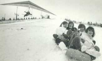 Don't look now, girls . . . . Etobicoke ordered to pay. Michael Robertson, a former world hang-gliding champion, swoops down the toboggan run at Etobi(...)