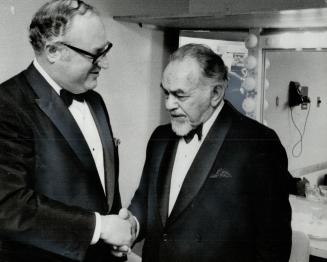 Edward G. Robinson (right) shakes hands with former Toronto mayor Philip Givens at All-Israel Hanukkah Festival at the O'Keefe Centre last night. Robi(...)