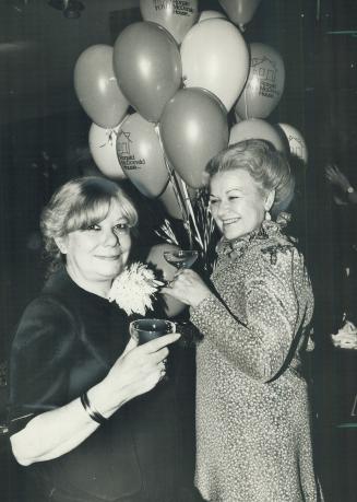 In the mood: Mrs. Stephen B. Roman, right, with Toronto couturiere Maggy Reeves. Mrs. Roman is wearing a Reeves design in silk. As part of the fun, ea(...)