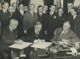 U.S. - Canada Reciprocal Trade Treaty is signed. A momentous international event is pictured above. It is the signing in Washington yesterday of the r(...)