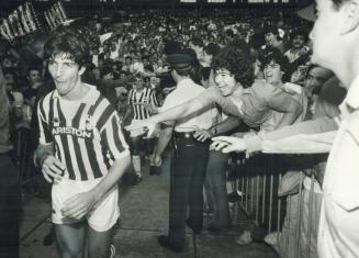 Hero worship. Fanatic soccer fans reach out last night to grab hold of Juventus star Paolo Rossi as he makes his way to the dressing room at Exhibitio(...)