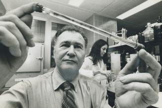 Dr. Aser Rothstein, director of the Hospital for Sick Children, holds a vial with bands of different proteins from the membranes of human red blood ce(...)