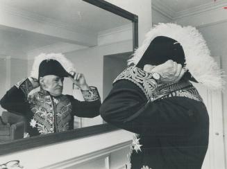 Lieutenant-governor W. Earl Rowe, resplendent in his braided Windsor suit, checks ostrich-plumed hat before setting out with military escort for openi(...)