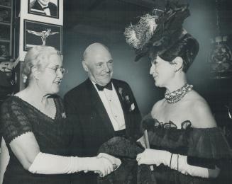 Mrs. Earl Rowe shakes hand of Mrs. Arthur M. Winton while Lieutenant-Governor Earl Rowe looks on. The old with their memories and the young with their(...)