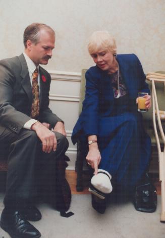 June Rowlands shows rival Jack Layton where her ankle was fractured earlier this week