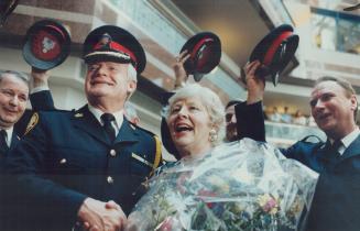 Hats off: June Rowlands beams and grasps Chief William McCormick's hand as officers doff their hats to her