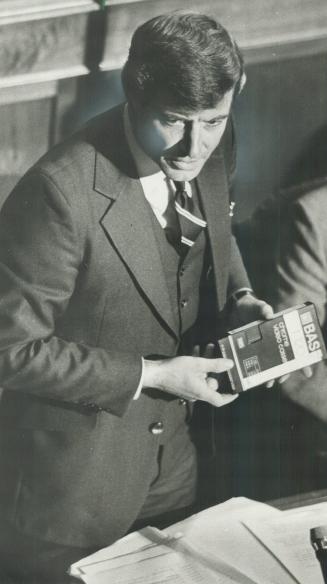 Two-minute tape: Liberal MPP Albert Roy, left, with his two minute Proverbs-Bullied tape, yesterday asked Attorney-General Roy McMurtry why a weapons charge was laid against Proverbs
