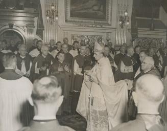 Wearing the vestments of his liturgical rank, Archbishop Roy is seen during the procession in the basilica, flanked by some of the clergy in atttendan(...)