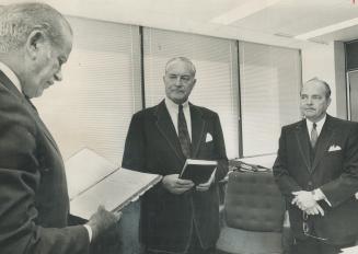 New stock boss sworn. The new chairman of the Ontario Securities Commission, Edward A. Royce (centre) is shown in by cabinet clerk John Young as Lesli(...)