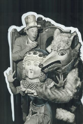 Story-teller Jan Rubes of Laterna Magika keeps a wary eye on Little Red Riding Hood (Loretta Sullivan) and The Big Bad Wolf (Janine Ralph)