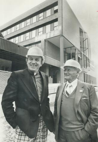 Rev. Robert Rumball (left) and Conn Smythe in front of new centre for deaf
