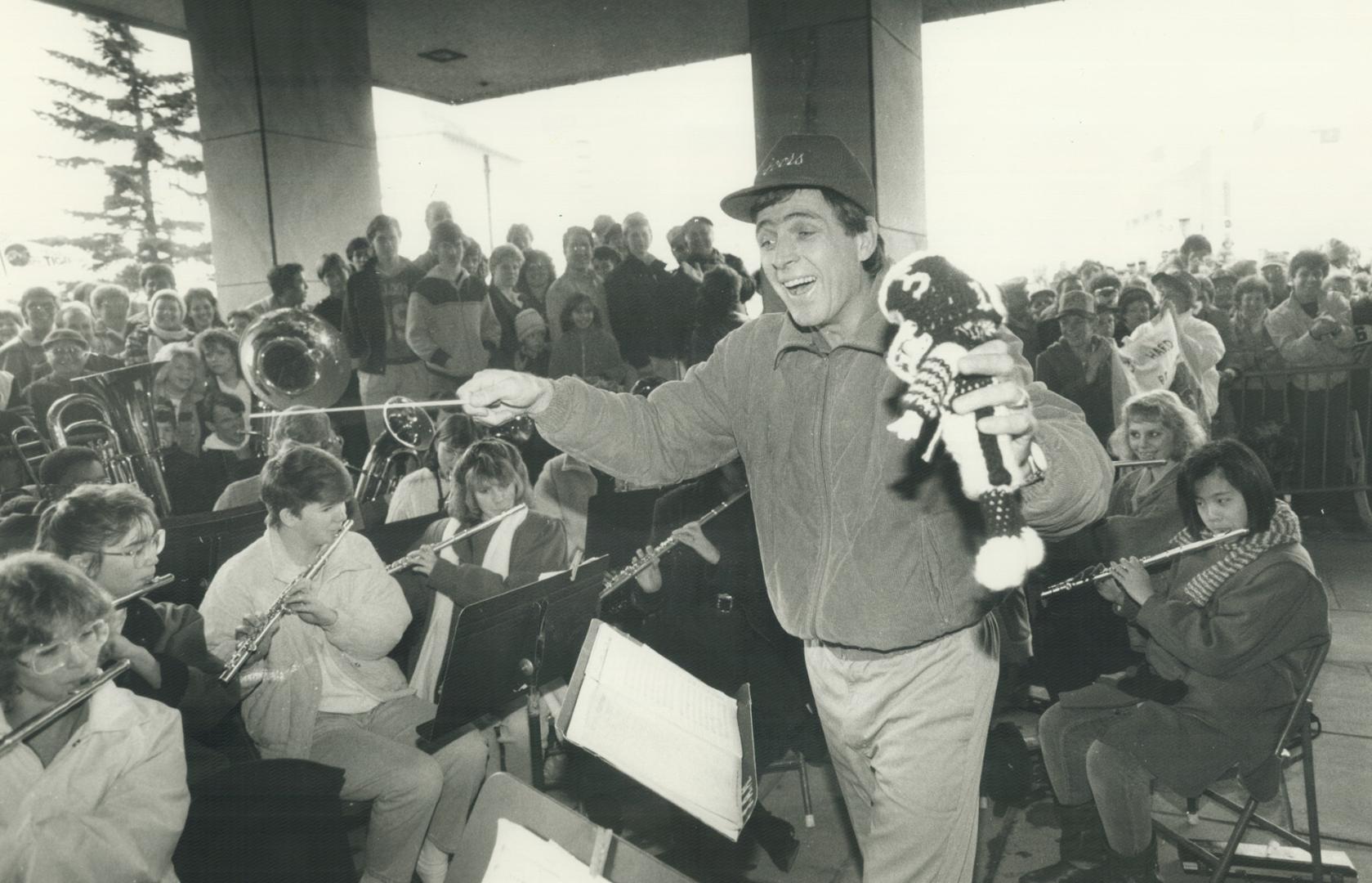 Tiger-Cats kicker Bernie Ruoff, with Ticat doll in hand, leads the junior band of Sir Allan MacNab High School during victory celebration yesterday at(...)