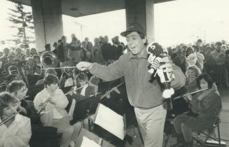 Tiger-Cats kicker Bernie Ruoff, with Ticat doll in hand, leads the junior band of Sir Allan MacNab High School during victory celebration yesterday at(...)
