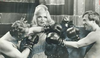 Now, now, boys! Mae West, alias Toronto's remarkable female impersonator Craig Russel, last night sparred with two guest 'boxers' on the set of Canada(...)