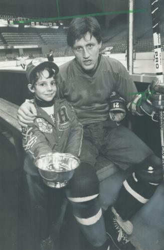 My here. Troy Noseworthy, 7-year-old forward who plays with Humberview's minor atom (9-year-old) team in North York Hockey League, shows Maple Leaf's (...)