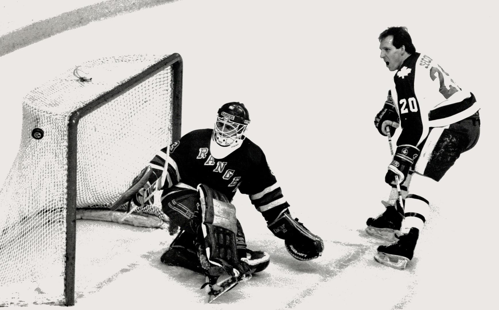 That was close. Forward Al Secord of the Maple Leafs watches with open mouth as his shot zooms past New York Rangers' net and goalie Bob Froese during(...)