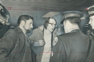 Ward 7 aldermen John Sewell (left) and Karl Jaffary, who easily won re-election, argue with police at City Hall who refused entry to their supporters.(...)