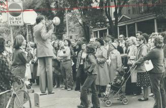 Bullhorn in hand, Mayor John Sewell talks to Parkdale residents and people on walking tour through the area