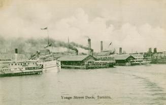 Image shows a few boats and a wharf.