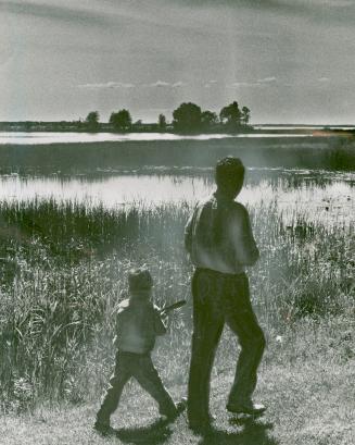 Undeveloped island is seen in background as Ted and Raymond Trumble head home after a day fishing on Lake Simcoe's Georgina island