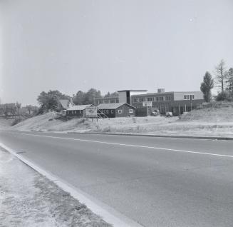 Black and white photograph of present CNIB building on Bayview Avenue, with several wooden stru ...