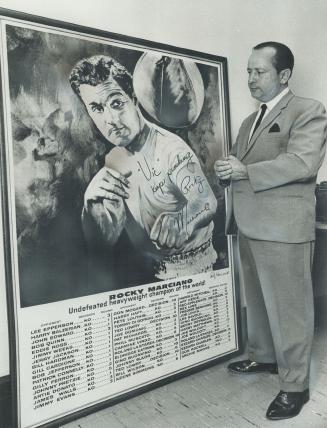Fond memories: Former Canadian fight champ Vic Bagnato looks at giant memento he received from late Rocky Marciano.