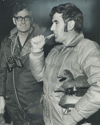 Calling for ringo, Canada's duck-calling champ Ray Baldakin, of Etobicoke, tests his sound as he gets ready to try to lure duck with beak held shut by ring. [Incompelte]