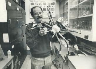 Bug expert David Barr with enlarged model of common gardon spider, his favorite kind of insect
