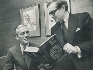 Chartered accountants George Ovens (left) and Don Beach discuss their book, Business and Securities Valuation. The 400-page textbook, for students and businessmen, was released yesterday. Most Canadians will never pay capital gains tax, says Ovens, and a lot of people are unnecessarily panicking.