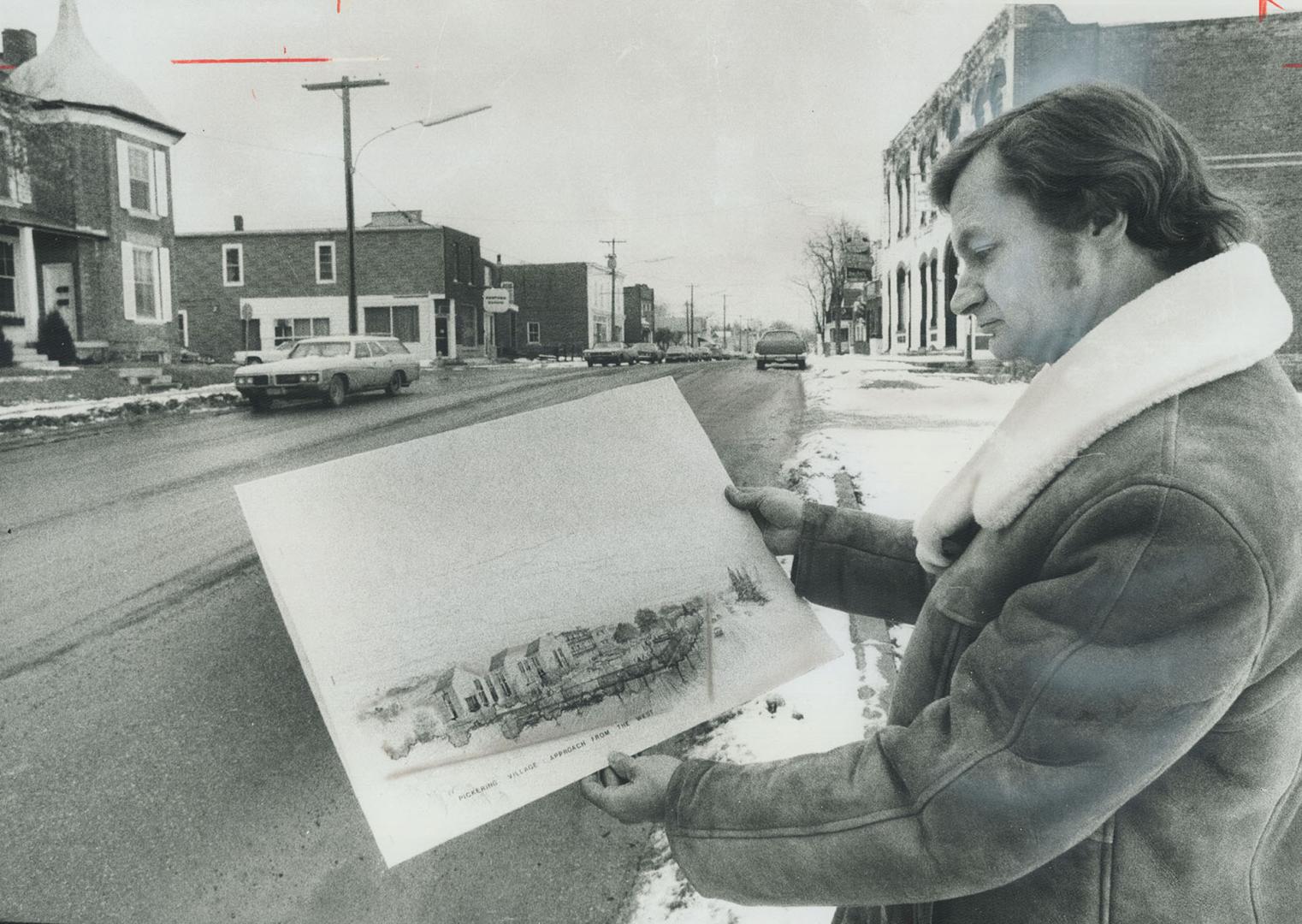 His plan to preserve Pickering, Architect William Beddall looks over sketches of a plan he has proposed to revitalize commercial core (background) of Pickering Village.