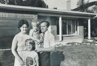 The Belcourt family, Patricia, Marc, and children Lisa, 3, and Stephen, 7-stand outside their house in West Hill which they sold for $54,000, only to find 10 days later it had been resold for $63,000. Belcourt has asked the Supreme Court of Ontario to cancel the first sale and refund the $2,700 real estate commission. They have been offered the $9,000 and the commission out of court.
