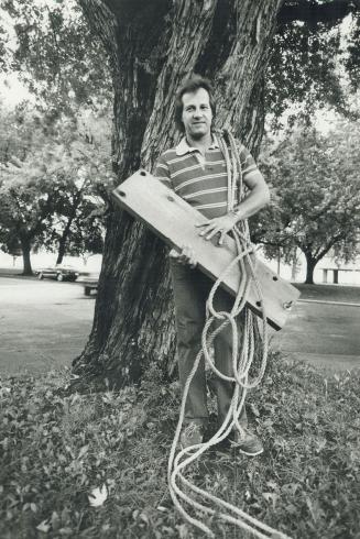 Didn't know the ropes: Terry Bey of Kippendavie Ave. holds his hand-made swing, hacked down by City Hall because he hung it from a city-owned tree.