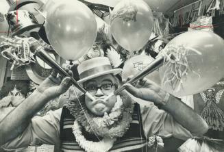 Showing how his wares work - almost all at the same time - is Ballon King Otto Bishof. He estimates he'll sell about 50,000 balloons and about 30,000 party hats, horns, noise-makers, bells and whistles to bring in the New Year. After 11 years in the business, he says he still has a lot of fun. Bischof also rents out canisters of helium gas to fill balloons, and he and staff also decorate some hotels for the festivities.