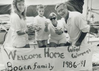 Here's to home: The Bogger family toast their return to Toronto yesterday, after spending five years travelling around the world in their sailboat, Wind Woman, From left, Jennifer, Alex, Tanis and Peter.
