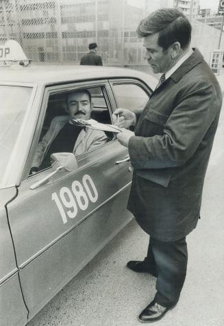 Al Boisvert, shown here checking cabbie Robert Boyd, is one of 33 inspectors with Metro Licensing Commission. It's an unpopular agency. A dump truck operator once vowed he would run over Al Boisvert.