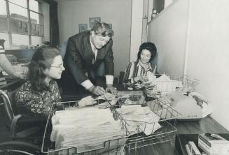 Business is Booming, for Laurier Life and here's a deskful of new orders for the company's president, Ernest Brooker. With no salesmen and using only direct-mail promotion techniques, Laurier Life has found a big insurance market in areas - such as older clients - long-established firms sometimes neglect.