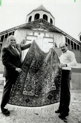 Working for a cause: Joining in preparations for a sale of rugs are businessman Kevork Kololian, left, and Arts Babikian, of the Armenian National Committee.
